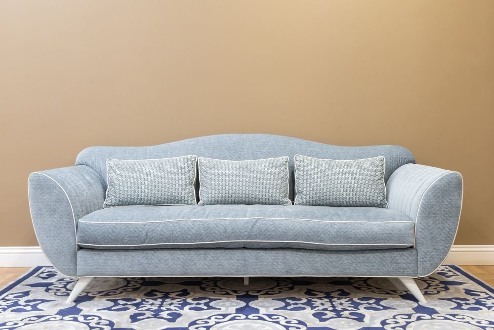 Upholstered sofa in a furnished interior